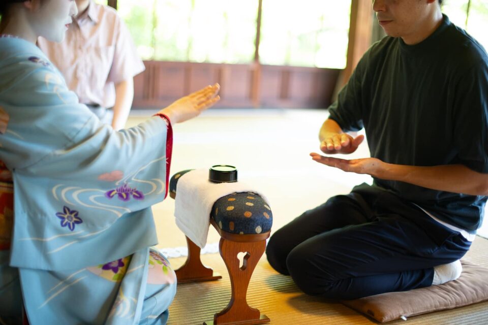 Maiko and guest enjoying a traditional ozashiki game in Kyoto